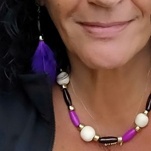 Purple feather earrings and colorfully beaded necklace